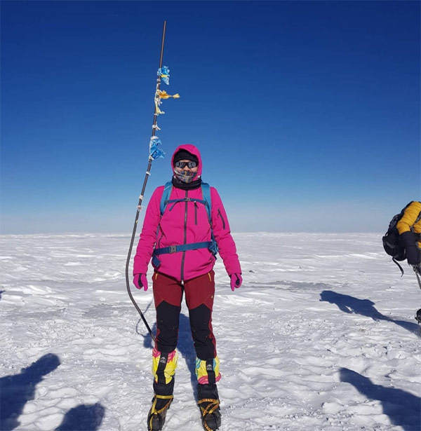 Tsevelmaa, a living liver donor, standing at the summit of Mount Sutai in Mongolia